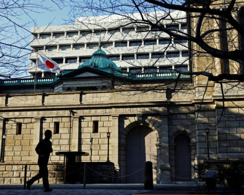BOJ keeps rates steady, cuts growth forecasts