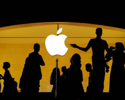 Apple girds for more trade war pain, trims buyback