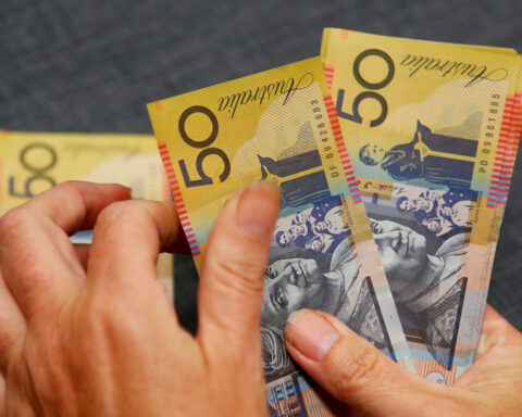 US dollar retreats, but off lows, after solid jobs report