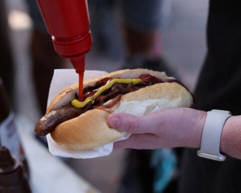 Australians sizzle on election day with 'democracy sausage' and 'budgy smugglers'