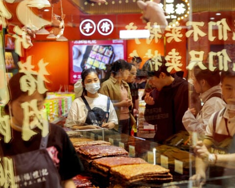 Chinese holiday spending inches up but trade war weighs on services