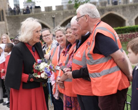 Queen Camilla visits poppy memorial for Victory in Europe Day celebrations