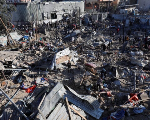 Israeli strikes on school housing displaced and on market kill 48 in Gaza, medics say