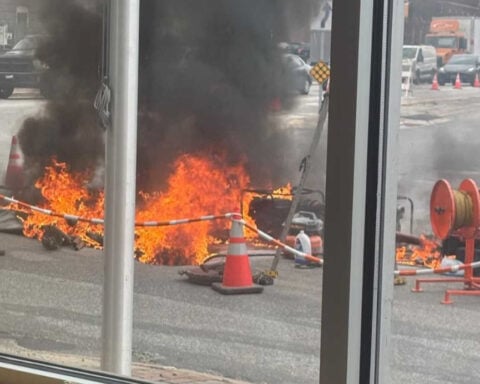 Worker burned by fire at road construction site outside city hall