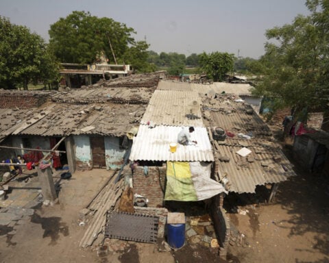 In one Indian city, reflective paint and bus stop sprinklers offer relief from killer heat