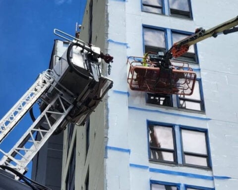 Firefighters assist during rescue after boom bucket gets stuck nine floors high
