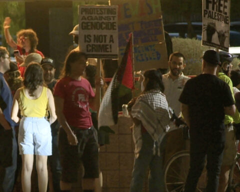 Protesters gather outside The Loft Cinema opposing 'October 8' showing