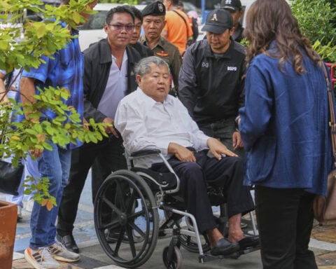 Thai construction magnate facing charge over Bangkok tower collapse surrenders to police