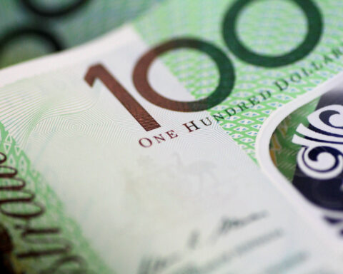 Australia dollar slips as RBA cuts rates, warns on global outlook