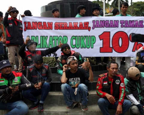 Ride-hailing drivers in Indonesia hold protests to demand better pay