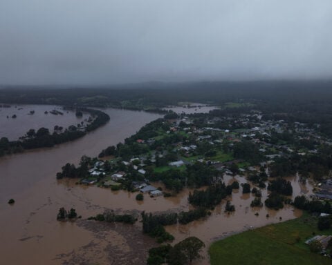 Flash floods cut off inland Australian towns, residents flee to rooftops