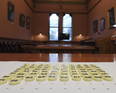 In New Zealand's Parliament, a battered cookie tin decides which new laws get debated