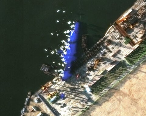 North Korea arrests four over failed warship launch as images show vessel shielded from prying eyes