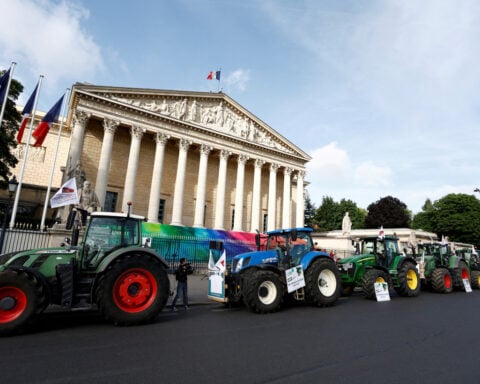 French farmers bring tractors to Paris to press for looser rules