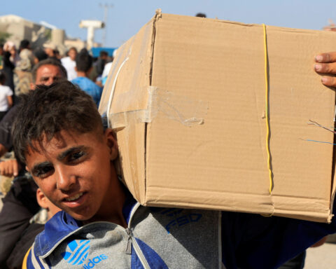 Palestinians rush US-backed aid centre despite concerns over checks