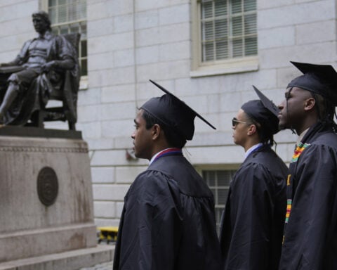 Harvard grads cheer commencement speakers who urge the school to stand strong
