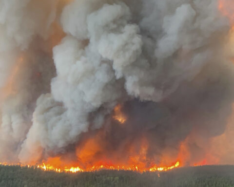 A Canadian prairie city virtually deserted as fires rage and thousands more evacuees expected