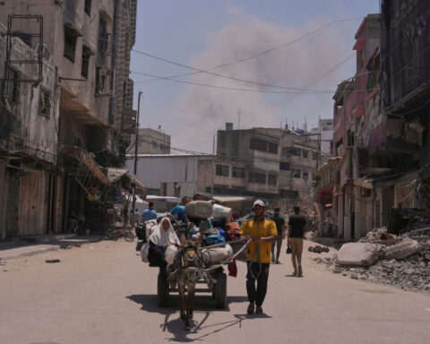 Hungry Palestinians in Gaza block and offload dozens of UN food trucks