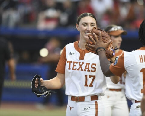 Atwood's hit on intentional walk attempt gives Texas a 2-1 win over Texas Tech in WCWS finals opener