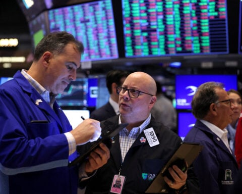 US stocks end up on jobs data, China hopes; Tesla bounces