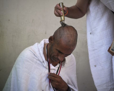 Symbolism and smiles during the stoning of the devil ritual at the Hajj