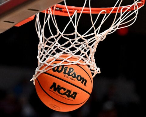 US judge approves settlement allowing NCAA schools to pay athletes