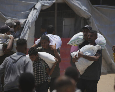 Palestinians say Israeli fire kills 12 near aid sites. Israel says it fired warning shots