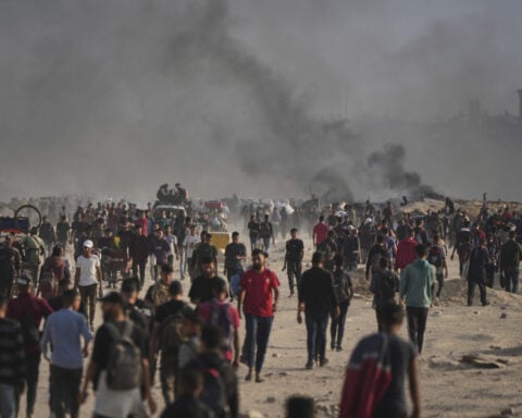 Palestinians say Israel and its allies fired on a crowd near Gaza aid site. Hospital says 14 killed