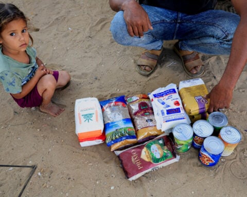 A professor in Gaza braves bullets and bodies to reach Israeli-approved aid