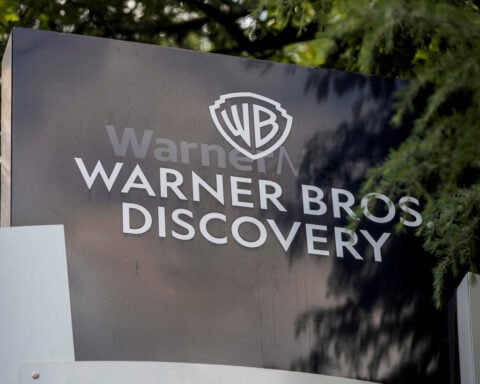 Warner Bros' credit rating downgraded to junk by Fitch on split-up