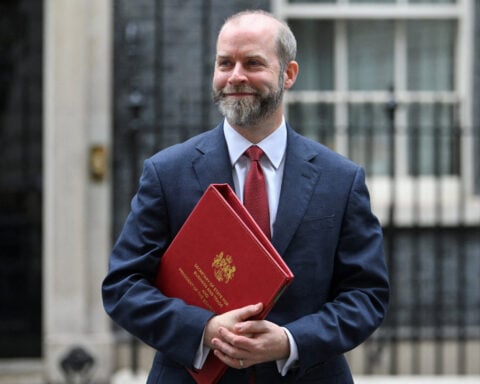 Britain ready to implement US tariff deal, trade minister says