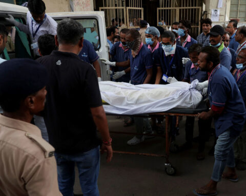 Sole survivor of Air India crash lays his brother to rest after leaving hospital