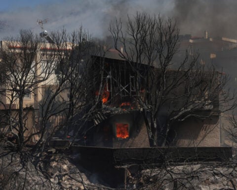 Greece battles wildfire in coastal town near capital