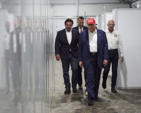 Trump tours Florida immigration lockup and jokes about escapees having to run from alligators
