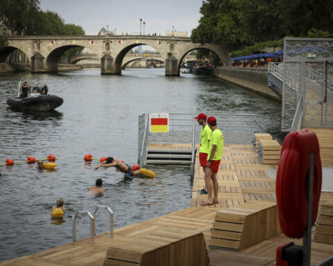 Joyful Parisians take a historic plunge into the Seine after 100 years