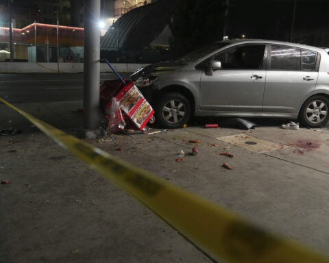 Man whose car struck crowd outside Los Angeles club, injuring 30, was shot, attacked by crowd