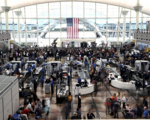 Passengers flee smoking jet on emergency slide after apparent landing gear problem at Denver airport
