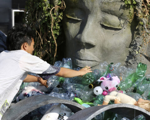Artist drowns sculpture in plastic waste in front of the UN during plastic pollution treaty talks