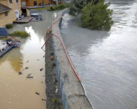 New river barriers prevented severe flood damage from a glacial outburst in Alaska, officials say