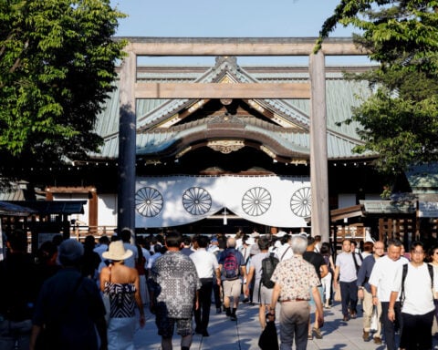 Japan minister joins crowds at contentious shrine to mark 80 years since World War Two defeat