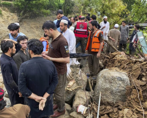 Flash floods triggered by heavy rains kill at least 49 people in northwestern Pakistan