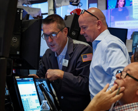 Dow briefly hits record high on UnitedHealth's gains; data in focus