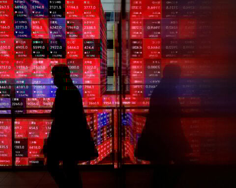 Japan's Nikkei hits record high as automakers rise on weaker yen