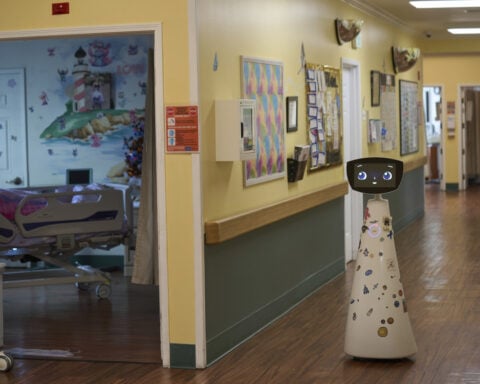 A robot programmed to act like a 7-year-old girl works to combat fear and loneliness in hospitals