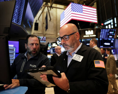 Dow, S&P 500 manage record closing highs; Nasdaq falls in volatile session