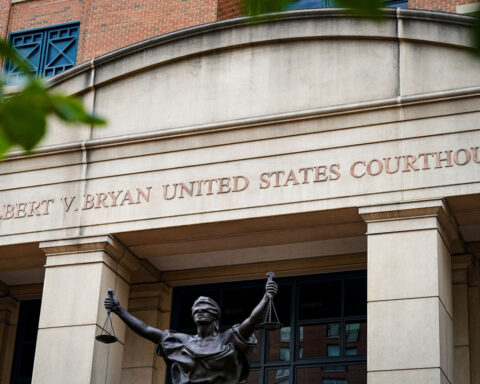 Fired federal prosecutor tapes a note about duty to the door on his way out