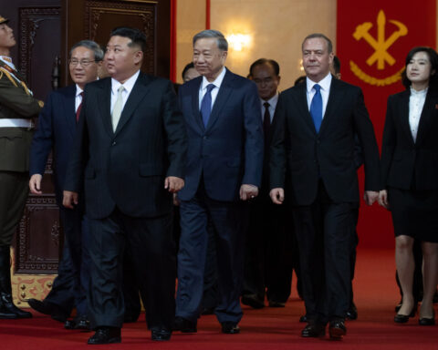 North Korea displays new long-range missile at a military parade celebrating Kim Jong Un