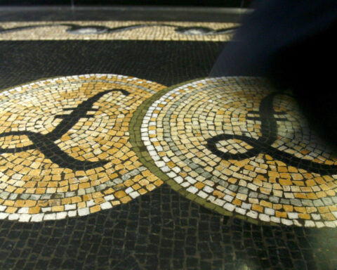 Sterling drops after UK data shows softer wage growth