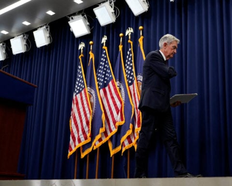 Fed's Powell says economy on firmer footing, QT end in view