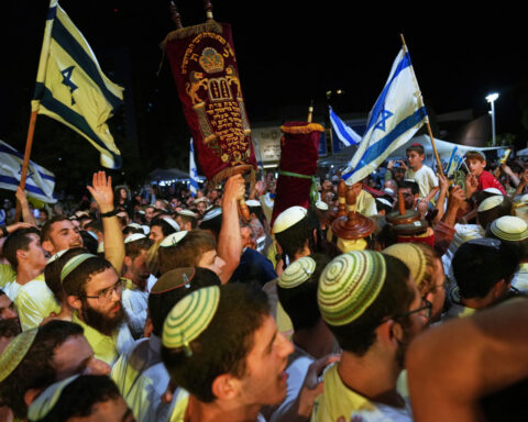 The Latest: Israel receives remains of 2 more hostages